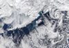 Alaska’s Winter Finale: A Satellite View of Polar Storms and Swirling Clouds